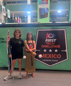 Harper and Astrid represented New Zealand at First Tech Challenge in Mexico, Harper wearing our kapa haka uniform proudly standing in front of the event sign.